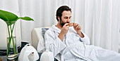 Man drinking tea at a spa