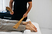 Massage therapy with bamboo sticks