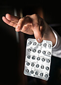 Person holding blister pack of empty pills