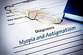 Astigmatism and myopia diagnosis on a form, conceptual image