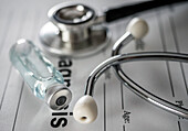 Medical form along with stethoscope and vials of vaccine