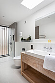 Wooden countertop vanity with a vessel sink, toilet, and walk-in shower in the bathroom