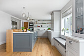 Bright kitchen with built-in bench under window and center kitchen island