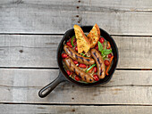 Pan-fried sausage with peppers and tomatoes