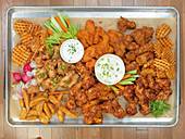 Chicken wings with garnishes and dips
