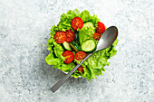 Healthy vegetables salad with fresh cucumbers, tomatoes, fresh iceberg salad leaves