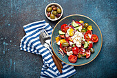 Greek fresh healthy colorful salad with feta cheese, vegetables, olives