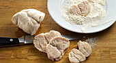 Veal sweetbreads being prepared: sweetbreads being dusted with flour