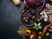 Seasonal groceries, healthy vegetarian ingredients on a dark background