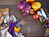 Top view seasonal vegetables and fruits, healthy vegetarian ingredients on a wooden background