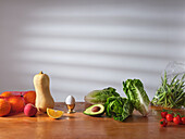 Fresh fruit and vegetables on wooden counter