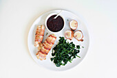 Turkey roulade with sweet potatoes, baby spinach, and cranberry sauce