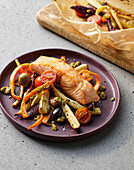 Salmon cooked in parchment parcels with colorful vegetables