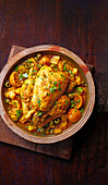 Whole braised chicken with citrus fruits and olives