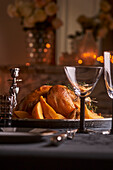Roast chicken with quinces on a festively decorated table