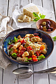 Ricotta gnocchi with olives and tomatoes