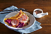 Potato pancakes with cabbage and smoked pork