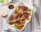 Breaded pork chops with beer sauce