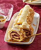 Sponge cake roll with almonds and strawberry jam