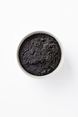 Activated charcoal powder in a small bowl