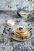 Pancakes with blueberries and icing sugar