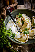 Filled pierogies with sour cream
