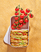 Sandwiches and cherry tomatoes in a snack box