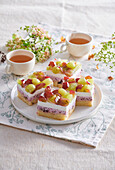 Triple layered cake squares topped with grapes