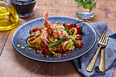 Pasta with prawns, cherry tomatoes and green asparagus
