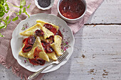 Dumplings with poppy seed butter and plum sauce