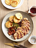 Grilled goose breast with plum sauce and potato cakes