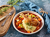 Baked chicken legs with root vegetables and potato mash