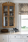 Antique glass cabinet above kitchen counter