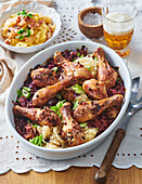 Roasted chicken thighs with braised cabbage and pasta with bacon bits