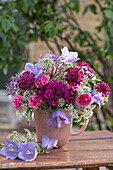Summer bouquet with carnations, bellflowers, starthistle and goutweed