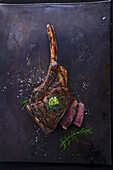 Grilled tomahawk steak with herb butter