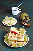 Waffles made with almond flour and cinnamon served with grapes and apples