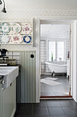 View from the kitchen into the bathroom with free-standing bathtub