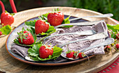 Fresh strawberries on spoons as table decoration