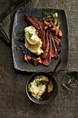 Roast beef slices with pickled garlic cloves and parsnip puree