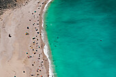 Myrtos beach panorama with crystal clear waters and unidentifiable bathers, Kefalonia island, Greek Islands, Greece, Europe