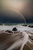 Double rainbow and long exposure creating movement at Traigh Bheag, Isle of Harris, Outer Hebrides, Scotland, United Kingdom, Europe
