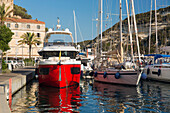 View across the harbour from quayside, early morning, colourful boats moored at jetty, Bonifacio, Corse-du-Sud, Corsica, France, Mediterranean, Europe