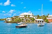 Boats at anchor in Pitts Bay, with pastel houses in the background with their traditional stepped roofs, Hamilton, Bermuda, Atlantic, Central America