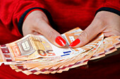 Woman's hands holding euro currency money banknotes. payment and cash concept and illegal money and greed concept, France, Europe