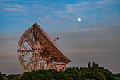 The Lovell Mark I Giant Radio Telescope with perfect alignment with the full moon, Jodrell Bank, Cheshire, England, United Kingdom, Europe