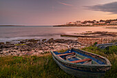 Blick auf Playa Punta Prima und Ruderboot in der Abenddämmerung, Punta Prima, Menorca, Balearische Inseln, Spanien, Mittelmeer, Europa