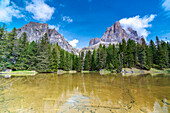 Majestic rock peak of Tofana di Rozes mirrored in the clear water of lake Bai De Dones, Dolomites, Lagazuoi Pass, Veneto, Italy, Europe