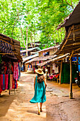 Woman walking in village street, Thailand, Southeast Asia, Asia