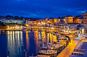 View of cafes, restaurants and boats in harbour at dusk, Cales Fonts, Es Castell, Menorca, Balearic Islands, Spain, Mediterranean, Europe